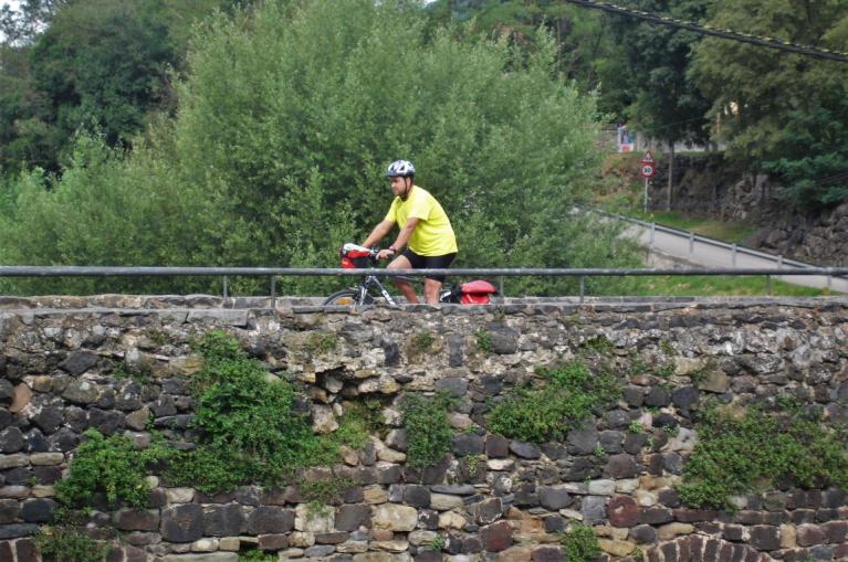 Cyclinst crossing a bridge in La Garrotxa